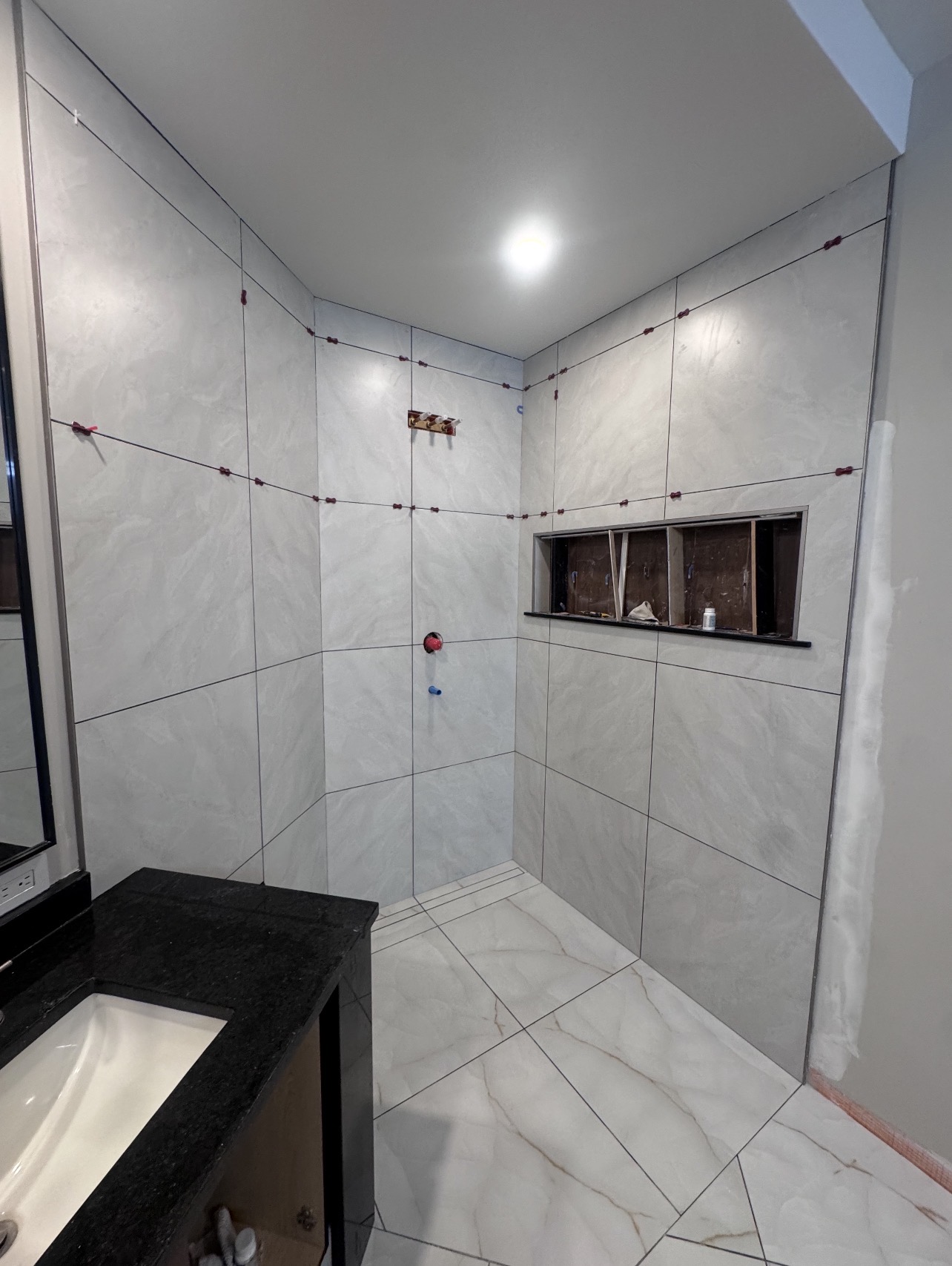Large format shower tile installation in progress — Orleans Flooring Co., Ottawa